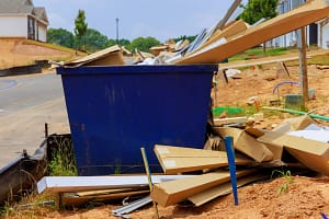 Construction debris loaded into a garbage bin rental in Calgary
